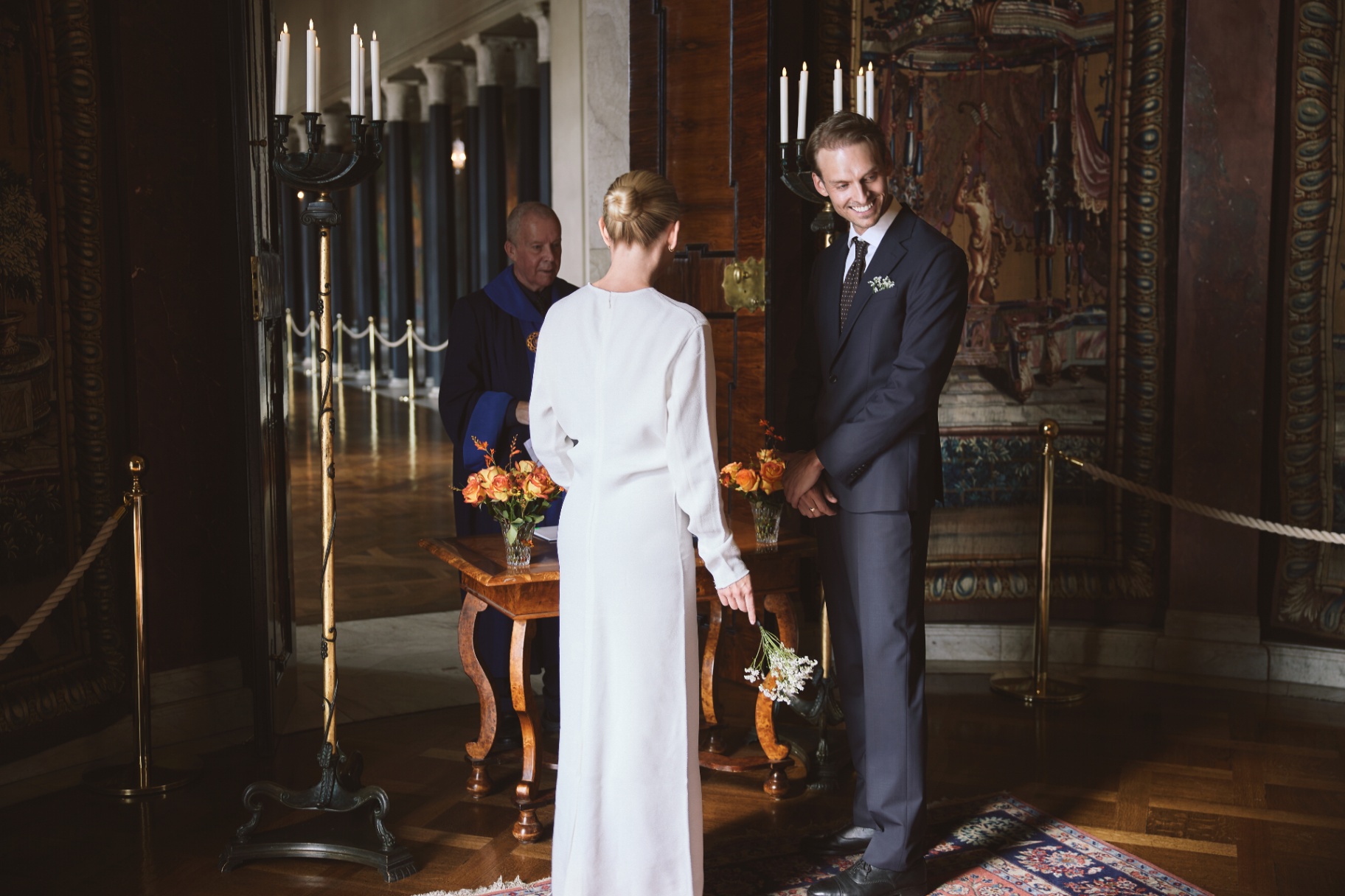 The groom smiling at the bride during the ceremony