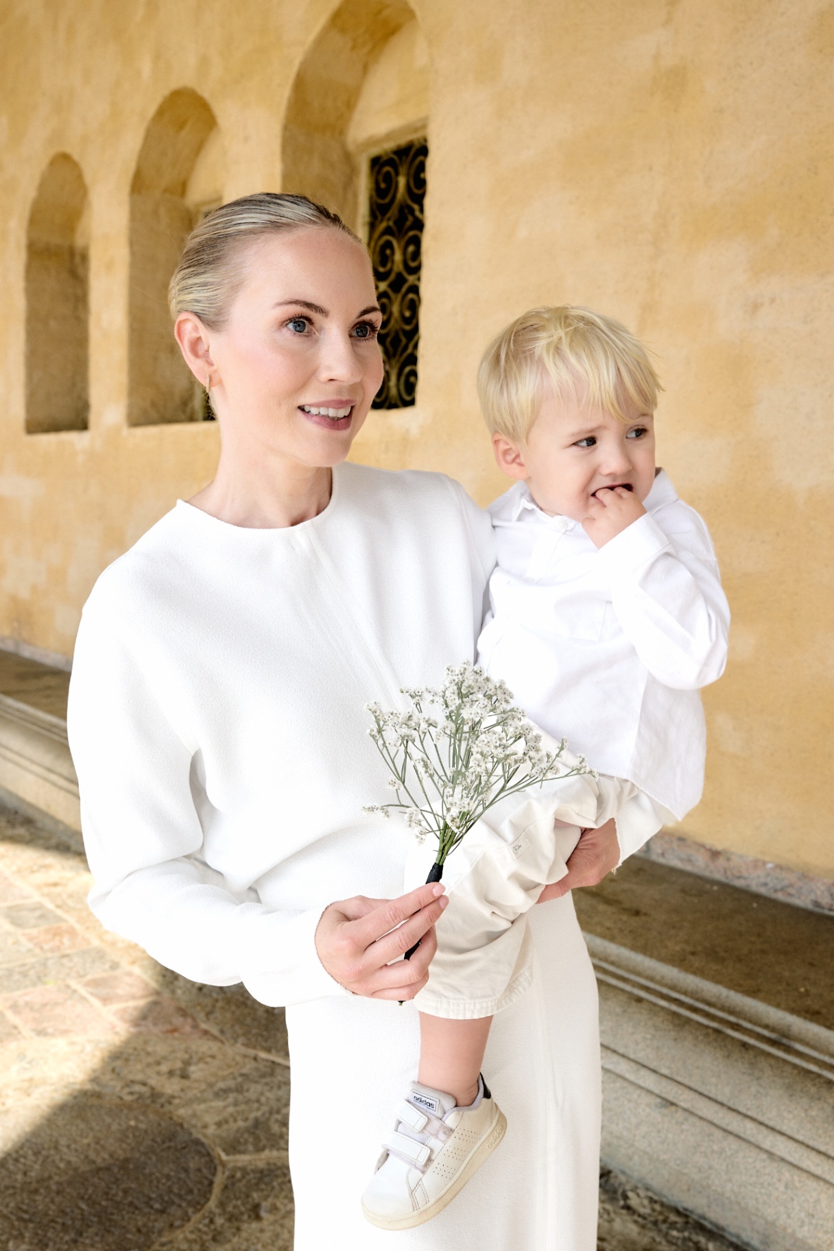 Elin holding her son and a sprig of flowers